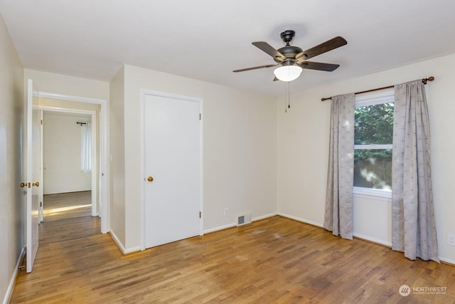 empty room featuring ceiling fan and light hardwood / wood-style floors