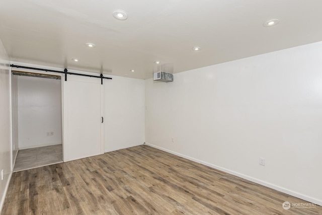 interior space with hardwood / wood-style flooring and a barn door