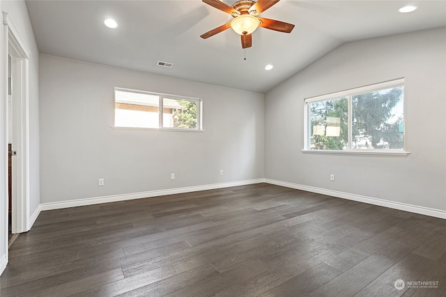 empty room featuring ceiling fan, dark hardwood / wood-style flooring, and vaulted ceiling