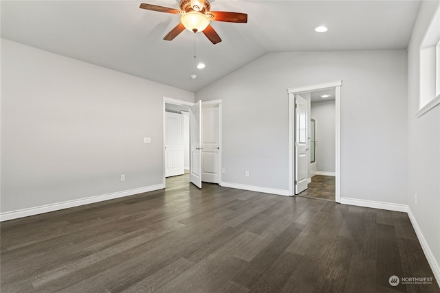 unfurnished bedroom featuring lofted ceiling, dark hardwood / wood-style floors, and ceiling fan