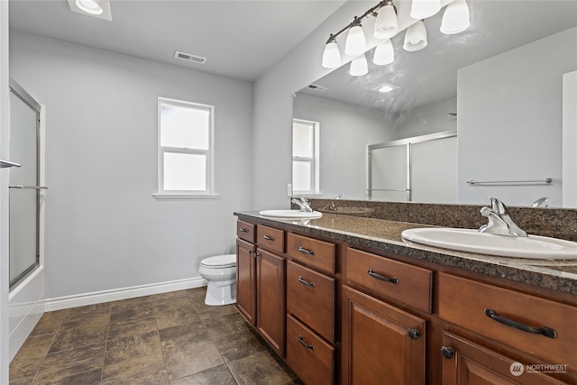 full bathroom with vanity, toilet, and enclosed tub / shower combo