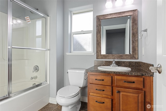 full bathroom featuring bath / shower combo with glass door, toilet, tile patterned flooring, and vanity