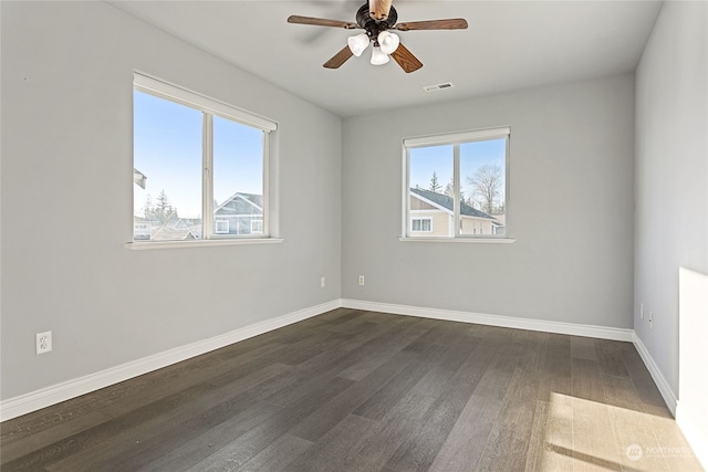 spare room featuring ceiling fan and dark hardwood / wood-style floors