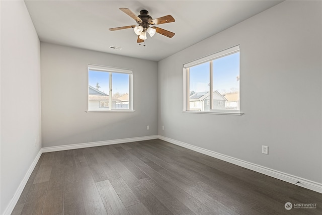 empty room featuring ceiling fan and dark hardwood / wood-style flooring