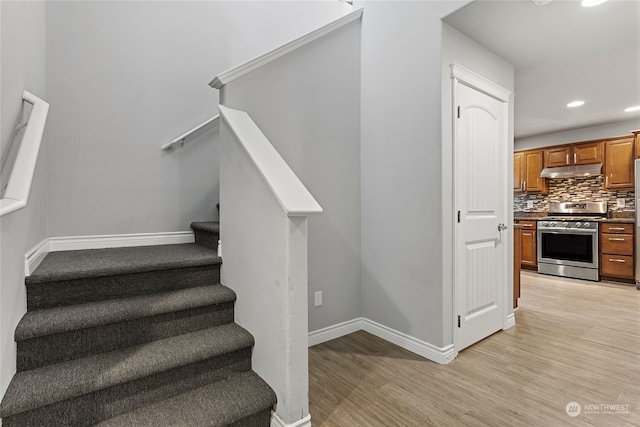 stairway with hardwood / wood-style flooring