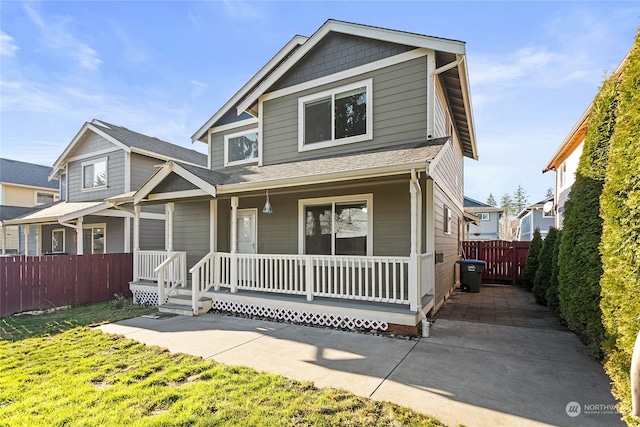 view of front of house with a front yard and a porch