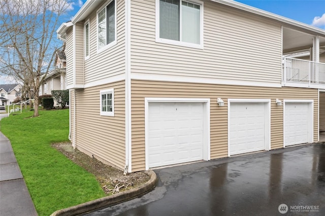 view of home's exterior with a garage and a yard