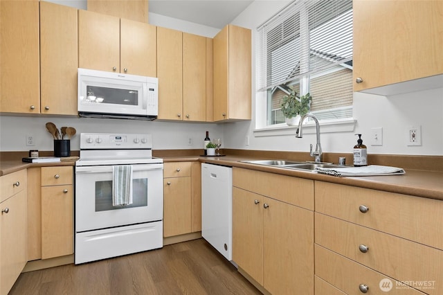 kitchen with a sink, white appliances, dark wood finished floors, and light brown cabinetry