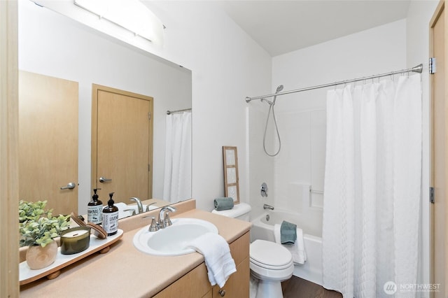 full bathroom featuring shower / bath combo with shower curtain, toilet, and vanity