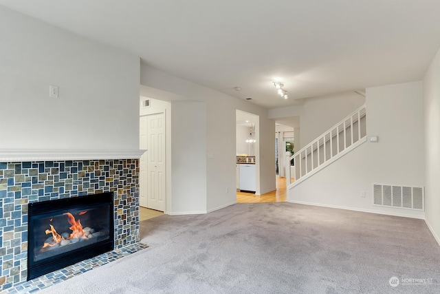 unfurnished living room with a fireplace and carpet floors