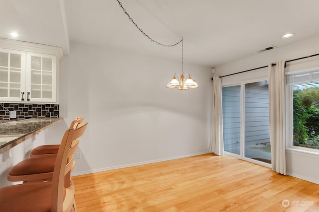 dining room featuring a chandelier and light hardwood / wood-style flooring