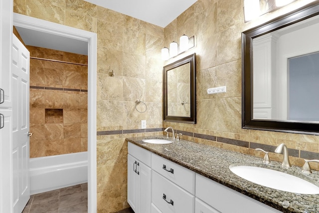 bathroom featuring tile walls, vanity, backsplash, and tile patterned floors