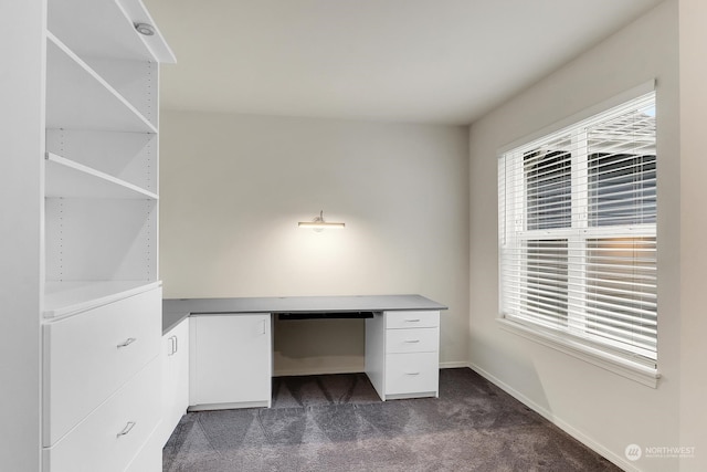 unfurnished office with dark colored carpet