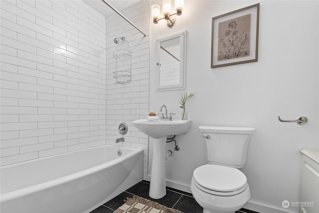 bathroom featuring tile patterned flooring, tiled shower / bath, and toilet