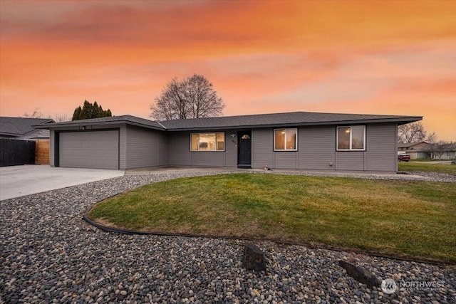 view of front of house featuring a yard and a garage