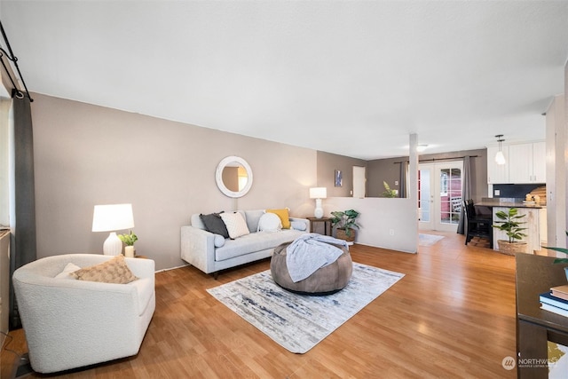 living room with light wood-type flooring and french doors