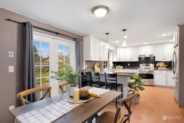 dining space with sink, french doors, and light tile patterned flooring