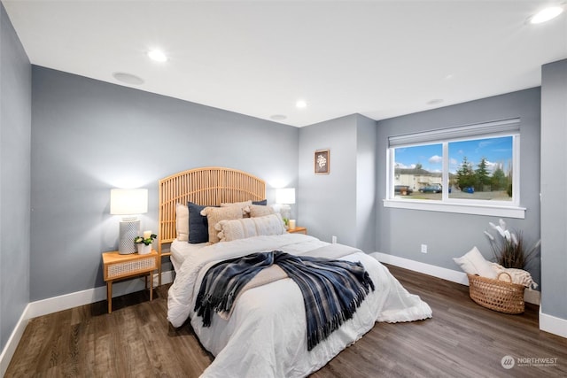 bedroom with dark hardwood / wood-style floors