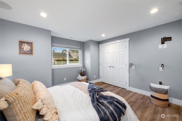 bedroom with a closet and hardwood / wood-style flooring