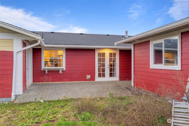 rear view of property featuring french doors and a patio area