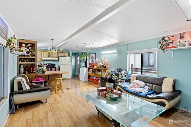 living room featuring light wood-type flooring and vaulted ceiling