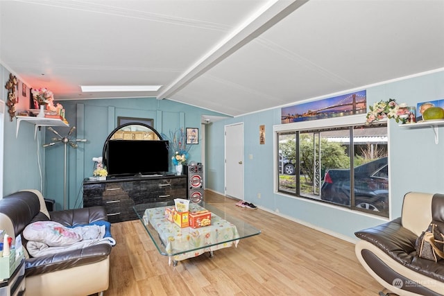 living room featuring lofted ceiling with skylight and hardwood / wood-style flooring