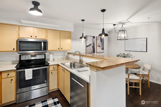 kitchen with sink, kitchen peninsula, decorative light fixtures, light brown cabinetry, and appliances with stainless steel finishes