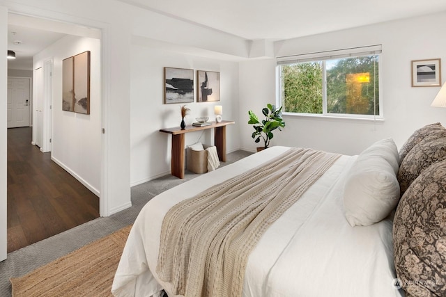 bedroom with dark hardwood / wood-style floors