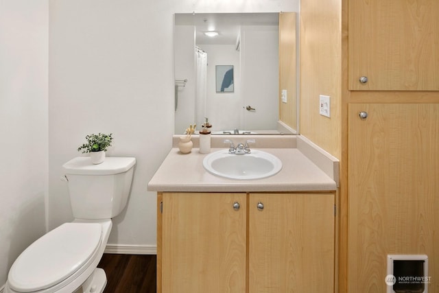 bathroom with vanity, wood-type flooring, and toilet