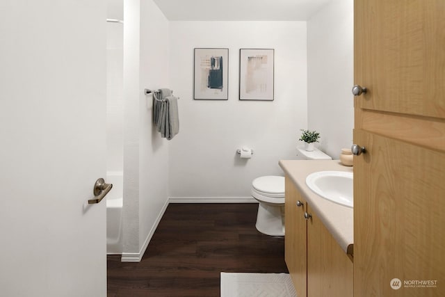 full bathroom featuring shower / bathing tub combination, hardwood / wood-style floors, vanity, and toilet