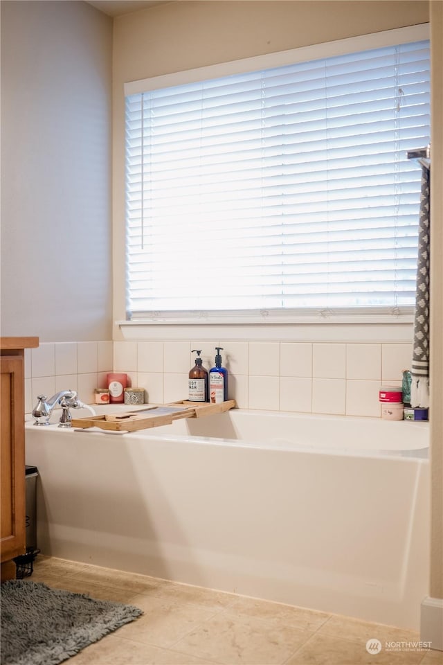 bathroom featuring a tub and plenty of natural light