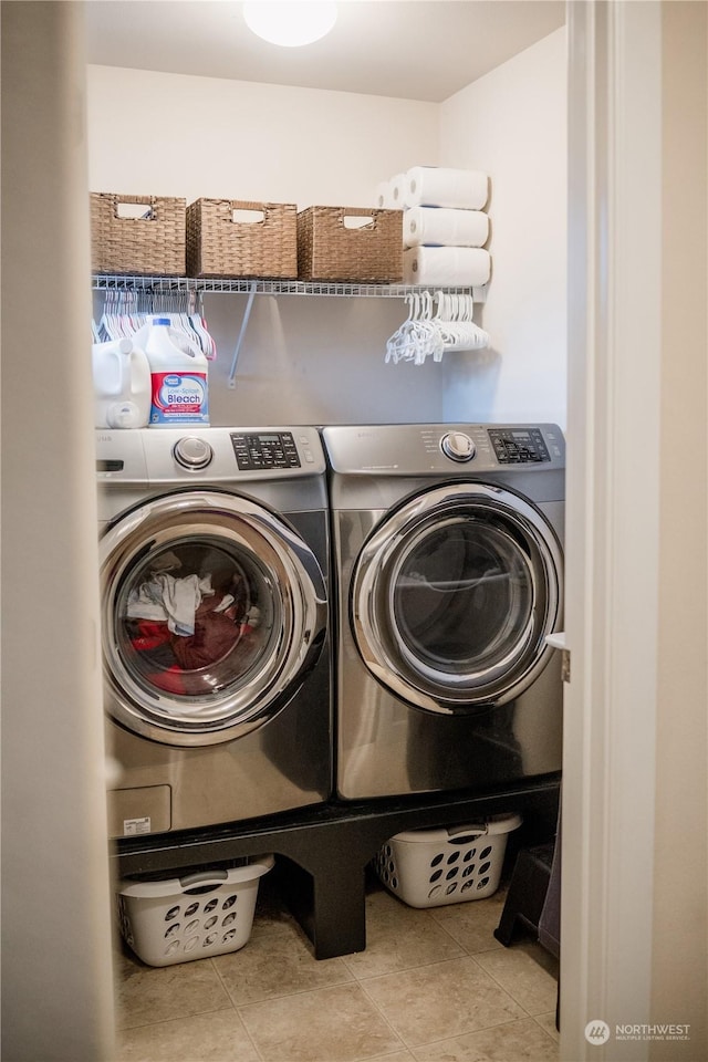 washroom featuring washer and dryer and light tile patterned flooring