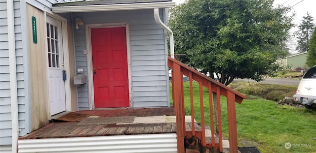 doorway to property featuring a yard