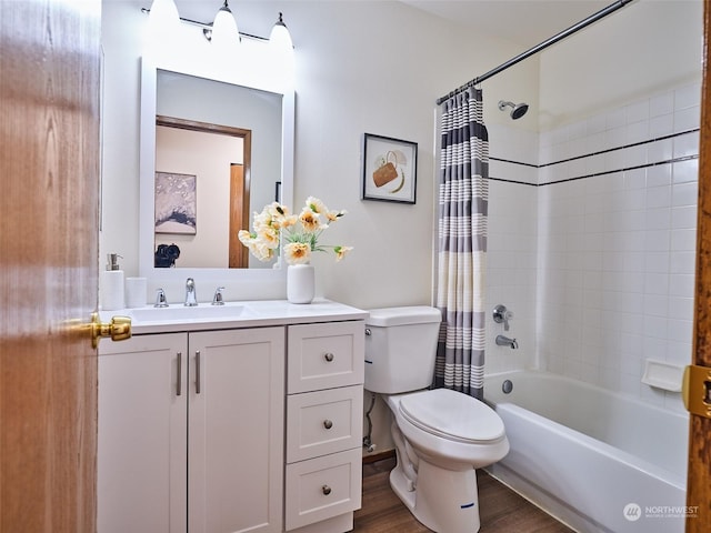 bathroom with toilet, wood finished floors, vanity, and shower / tub combo with curtain