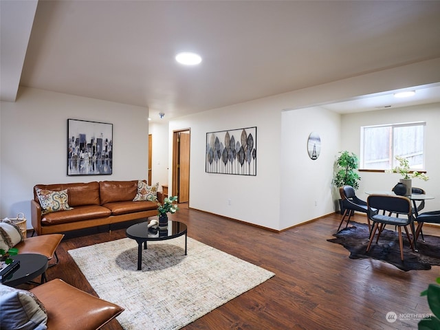 living room featuring dark wood-style flooring and baseboards