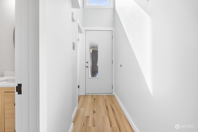 hall with light hardwood / wood-style flooring