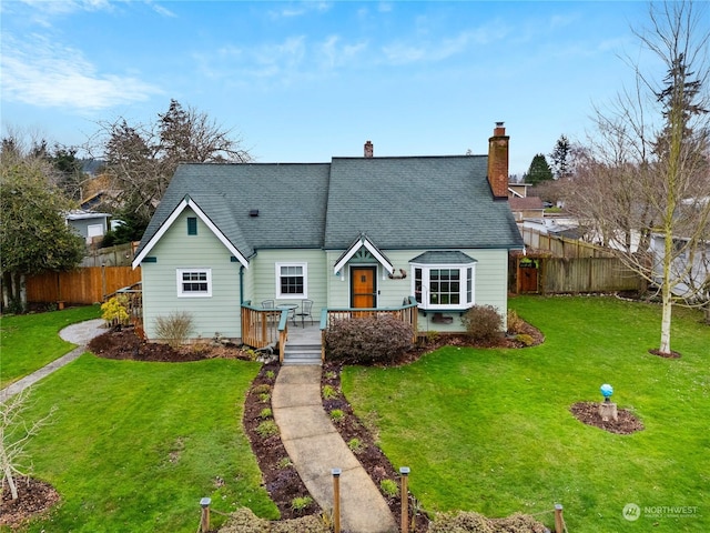 view of front of home featuring a deck and a front yard