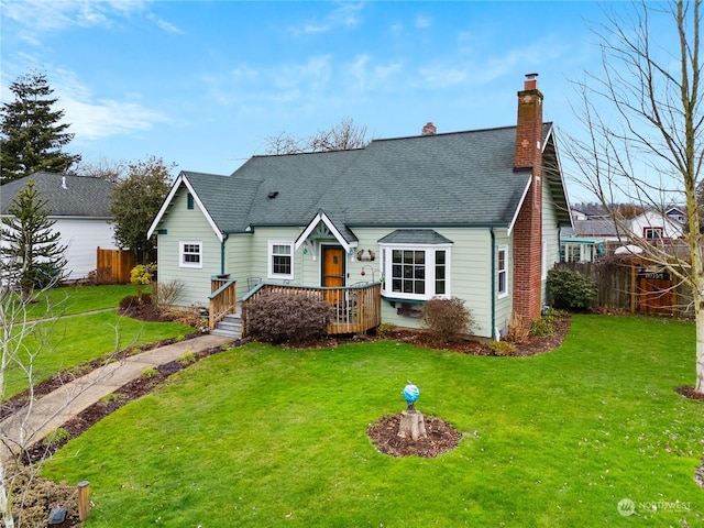 view of front of home featuring a front yard and a wooden deck