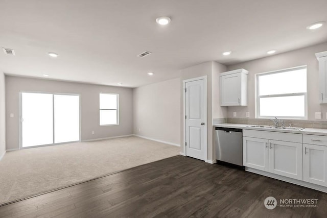 kitchen with white cabinetry, sink, stainless steel dishwasher, and dark hardwood / wood-style floors