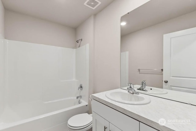 full bathroom featuring vanity, bathtub / shower combination, and toilet