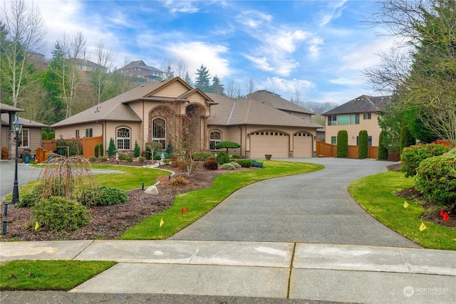 view of front of house with a garage and a front lawn