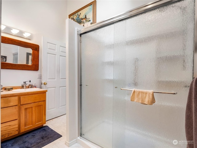 bathroom featuring vanity and a shower with shower door