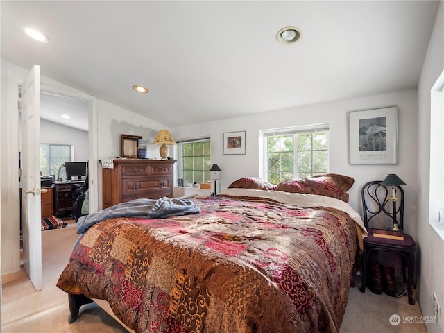 carpeted bedroom featuring lofted ceiling