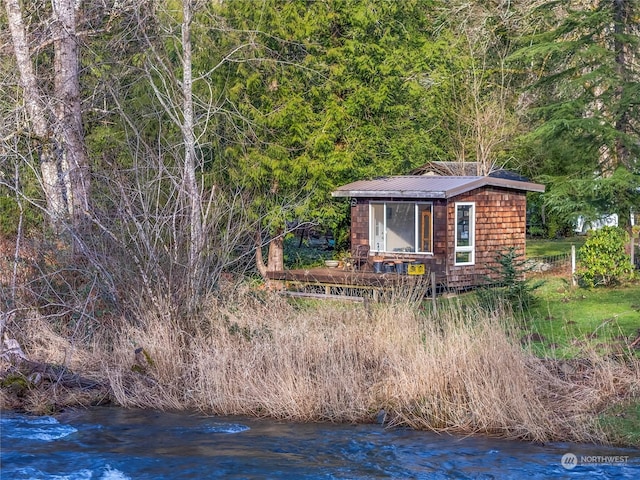 view of home's exterior with an outdoor structure