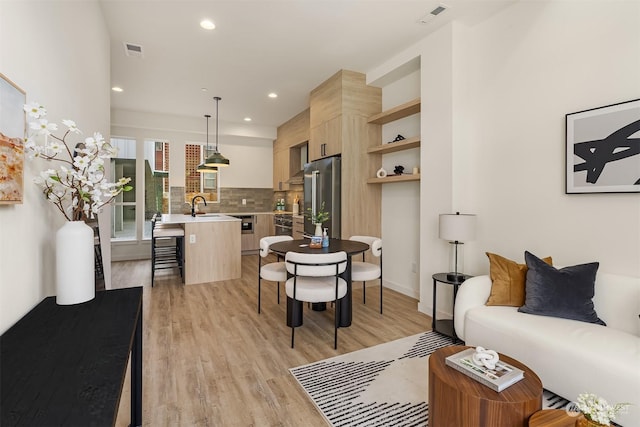 living room featuring light hardwood / wood-style floors and sink