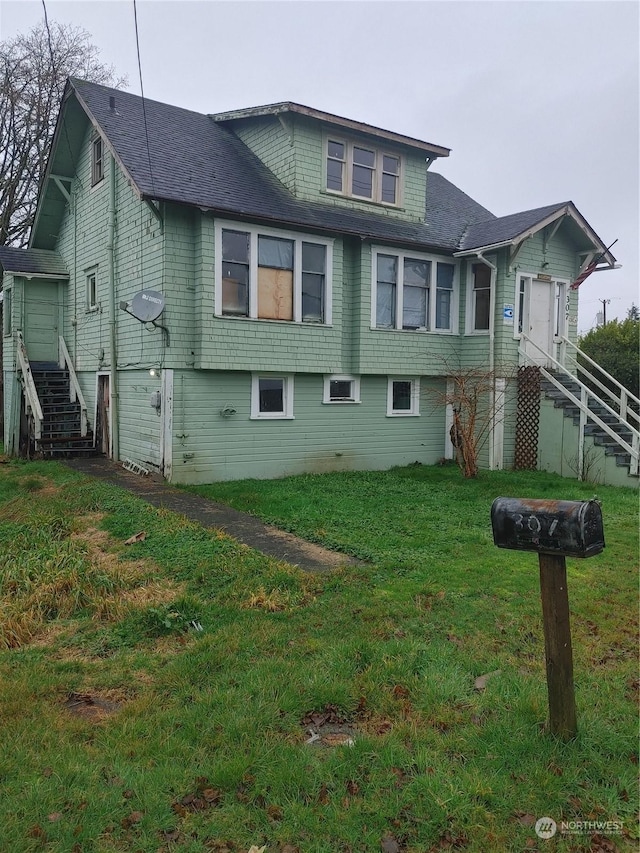 rear view of property with a yard