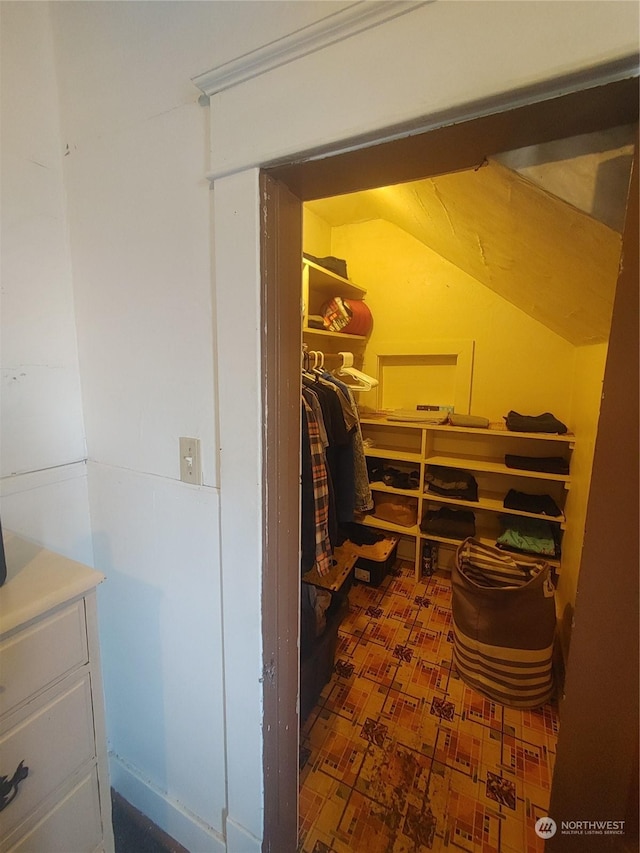 walk in closet featuring lofted ceiling