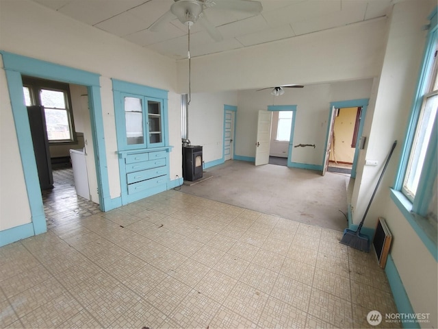307 S Exchange St, Aberdeen, WA 98520 - empty room with a ceiling fan and a wood stove