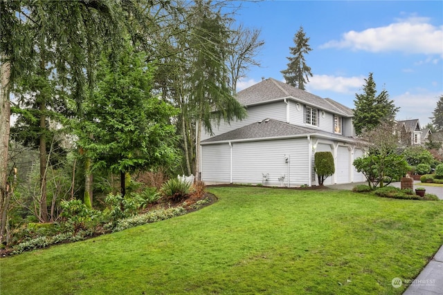 view of side of home with a garage and a yard