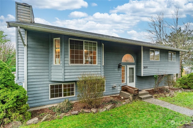 split foyer home with a front lawn